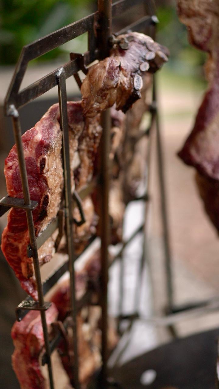 Dried meat hanging on a metal rack outdoors